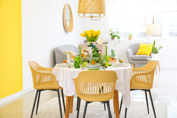 Interior of stylish room with dining table served for Easter celebration