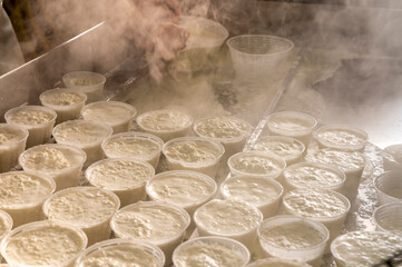 Process of making fresh white soft ricotta whey cheese on small cheese farm in Parma, Italy