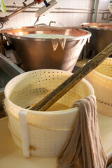 Process of making wheels of parmigiano-reggiano parmesan cheese on small cheese farm in Parma, Italy