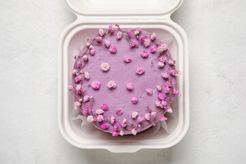 Plastic lunch box with tasty bento cake on light background