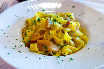 Italian food, firsh course dish, fresh homemade pasta tagliatelle with porcini mushrooms, Parma, Emilia Romagna, Italy