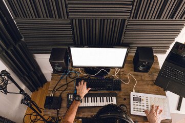 overhead view of young caucasian man working in his home music studio