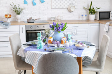 Dining table served for Easter celebration in kitchen interior