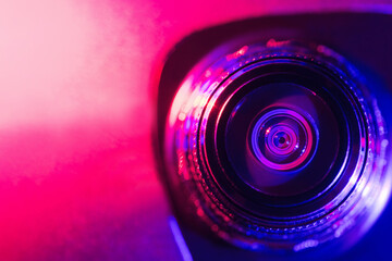 Camera lens with purple and pink backlight. Optics. Cyberpunk style