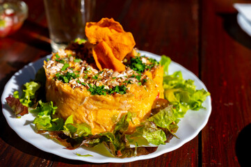 Dinner at guachinche, typical Canary Island establishment on Tenerife, where locally produced white or red wine served accompanied by homemade traditional food, sweet potato salad