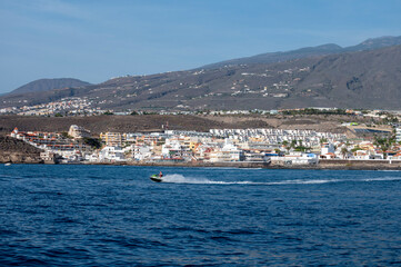 View on resorts and beaches of South coast of Tenerife island during sail boat trip along coastline, Canary islands, Spain