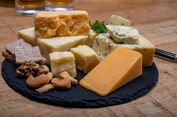 British drinks and food, glasses of Scotch whisky and cheeses collection, blue Stilton, Scottish coloured and English matured cheddar cheeses