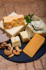 British cheeses collection, blue Stilton, Scottish coloured and English matured cheddar cheeses