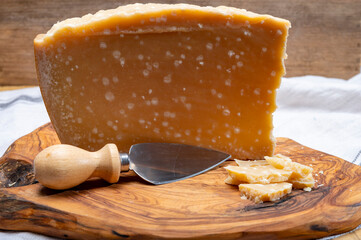 72 months very old Italian parmigiano-reggiano parmesan cheese from Parma has amber color, dry, extremely grainy and crumbly with very intense taste.