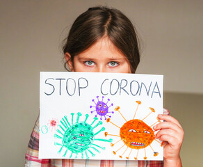  Little girl holding toy teddy bear in medical protective mask. Concept of kids protection during coronavirus Covid-19 pandemic. Vaccination, healthcare concept.
