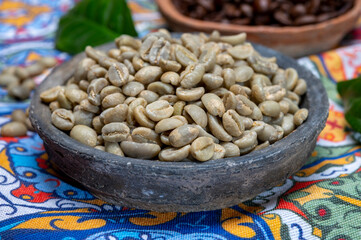 Green and roasted coffee beans from South America coffee producing region, from Colombia and Brazil with  mountain ranges and climate ideal for coffee growing