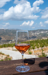 Wine industry of Cyprus island, tasting of rose dry wine on winery with view on vineyards and south slopes of Troodos mountain range.