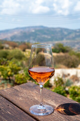 Wine industry of Cyprus island, tasting of rose dry wine on winery with view on vineyards and south slopes of Troodos mountain range.