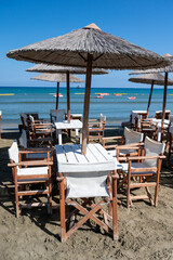 Fototapeta na wymiar Beach unbrellas and chairs on sunny sandy beach Lady's mile in Akritori, Cyprus