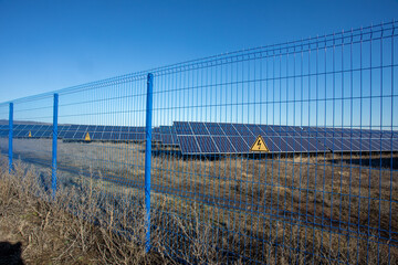 Private Solar panel field behind a protective fence
