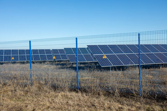 Private Solar Panel Field Behind A Protective Fence