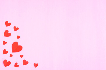 Red hearts papercut on pink background