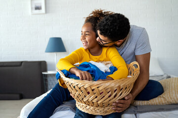 Black daughter helping father do household and domestic chores together