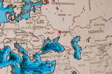 Wooden map of Europe with a pin in the conflict zone in eastern Ukraine after the recognition of...