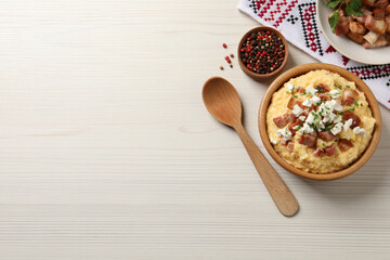 Delicious traditional Ukrainian banosh served on light wooden table, flat lay. Space for text