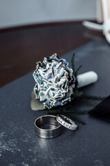 Wedding rings on the table. Wedding details for the ceremony. Wedding accessories. Close-up.