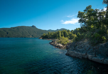 View of the Lake in the mountains in spring. Patagonian Coast Lake. Waves on the coast. Peninsula. Vertical Panoramic View. Relaxing Coast beach.	

