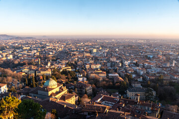 Fototapeta na wymiar The lower city of Bergamo bassa view from the Fortress in the upper city at sunset, Italy, Europe