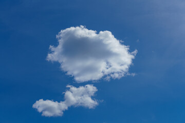Naklejka na ściany i meble Sunny blue sky with two flyffy white clouds