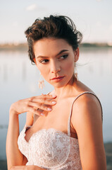 Close-up portrait of a brunette model girl in the role of a bride. Beautiful face, portrait at...