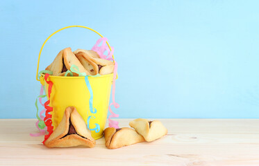 Purim celebration concept (jewish carnival holiday). Hamantaschen cookies over wooden table