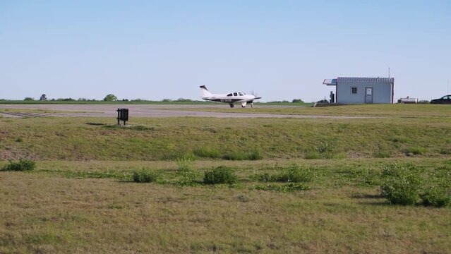 Small Aircraft Taxis Past a Building