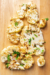 Cauliflower steak with spices cooks close-up. Flat lay. Vertical photo