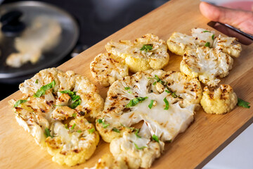 Cauliflower steak with spices cooks close-up. Selective focus
