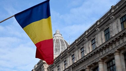 Romanian flag blowing in the wind in Bucharest, Romania - Powered by Adobe