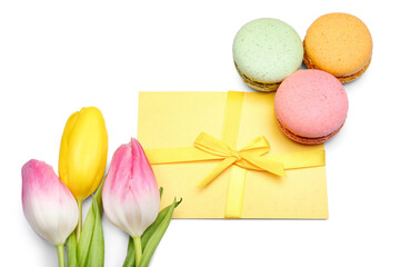Composition with card for International Women's Day celebration, macaroons and tulip flowers on white background