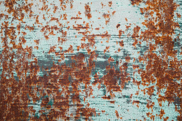 grunge rusty  metal plate covered with blue peeling paint
