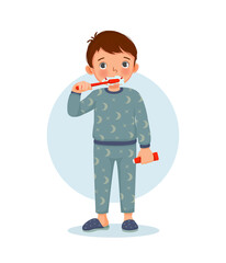 cute little boy in pajamas brushing teeth with toothpaste doing daily routine hygiene activity in bathroom