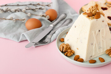 Delicious curd Easter cake with nuts on pink background