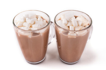 Two mugs with hot cocoa drink and marshmallow on a white isolated background.
