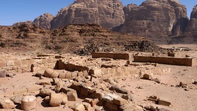 Walking along Wadi Rum the famous valley of moon tourist travel destination in the Jordan desert, historical ancient city ruins