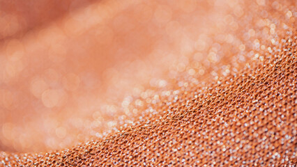 Detailed Macro Shot of an Orange Colored Piece of Cloth That is Wrinkled.

