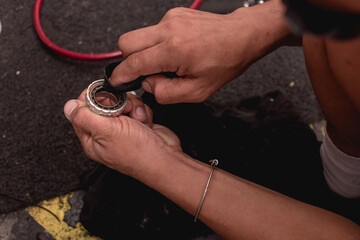 A repairman cleans the bearing of the bottom bracket with a small piece of cloth. Maintenance...
