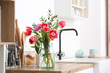 Vase with flowers on kitchen counter