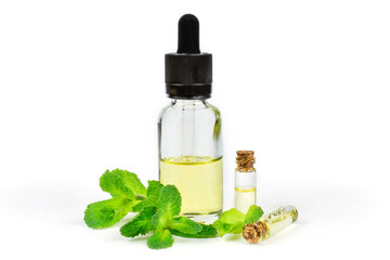Essential oil of fragrant mint (peppermint) in a transparent glass bottle with a pipette on a white insulated background. Aromatherapy (anti-fatigue, relaxation), spa, skin care.