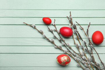 Naklejka na ściany i meble Painted Easter eggs and pussy willow branches on wooden background