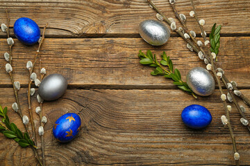 Fototapeta na wymiar Painted Easter eggs and pussy willow branches on wooden background