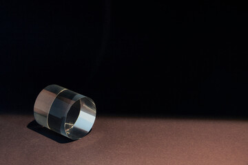 a clear cylinder on a dark cool background