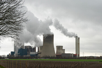 Fototapeta na wymiar Coal fired power station with smoking chimney