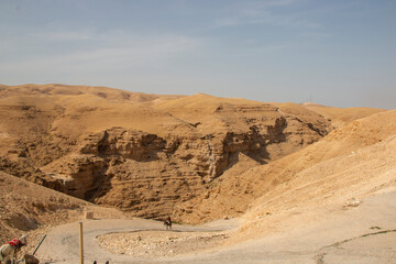 Man riding a donkey in the desert