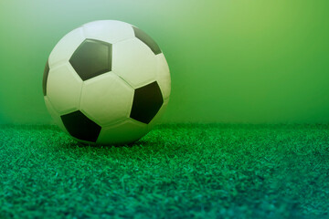 football on green field background , soccer ball on floor